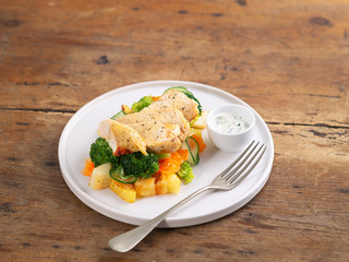 Healthy lunch, dinner. Healthy baked chicken breast with vegetables, grilled potatoes, cucumber, carrot, broccoli on a plate in a rustic style. Copy space. Proper nutrition. Dietary menu.
