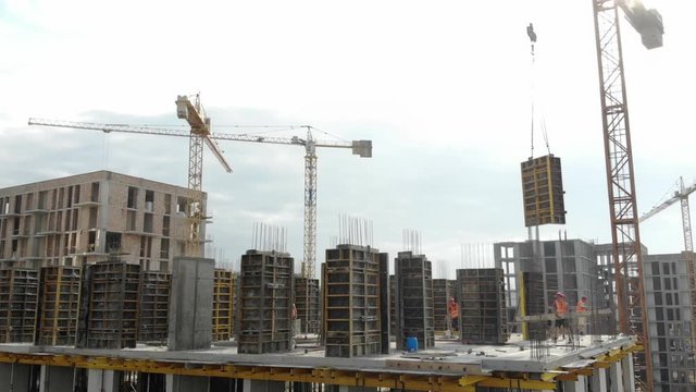 Aerial view of the construction site, and the construction crane from the top. Panorama of the construction site