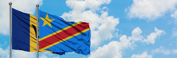 Fototapeta premium Barbados and Congo flag waving in the wind against white cloudy blue sky together. Diplomacy concept, international relations.