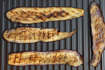 Fried eggplant on electric bbq, top view. Vegetarian course of aubergine. Healthy diet