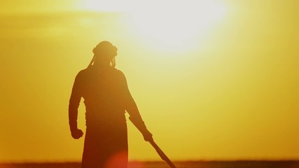 warrior with Kalashnikov at sunset day. fighter is training with a machine gun at sunset.