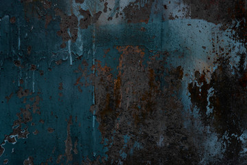 Abstract art texture background. Creative wall art close up. Beautiful dark background. Paint on the wall. Blue, grey, orange and yellow old cracked concrete wall surface