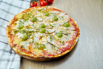 Italian, homemade sliced 4 cheese pizza with pear and grapes red sauce on a wooden table. Top view food with copy space. Flat lay