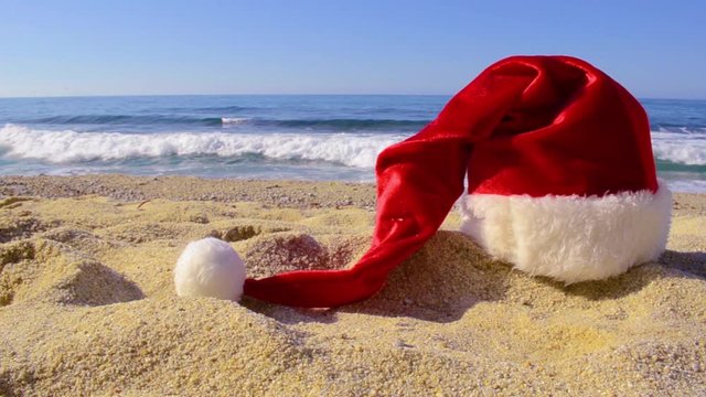 Santa Claus hat on the seashore. strong waves in the background. Christmas or New year on a tropical island. - video Описание (на английском языке)11