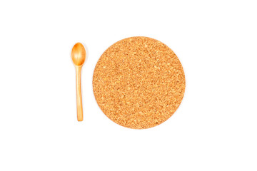 Top view of round stand under a plate or pan or glass with drink with wooden spoon . Made of cork. Isolated on white background.