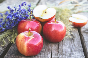 Ripe red apples on a wooden table. Vitamins and a healthy diet. Vegetarian concept.