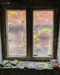 Dirty window in abandoned factory