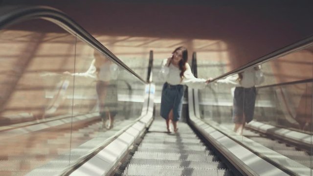selective focus of happy woman on escalator 