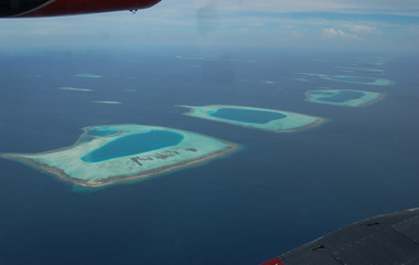 Naklejka na ściany i meble Weird forms of Maldivian atolls as seen from the local plane