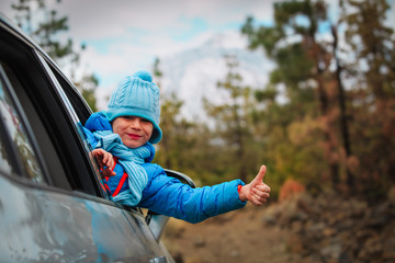 happy little boy enjoy travel by car in mountains
