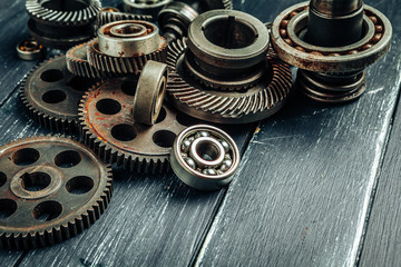 Car parts gears and bearings on wooden background