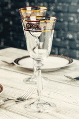 Close up shot of table setting for fine dining with cutlery and glassware