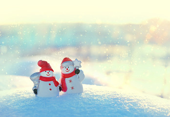 winter season background.  cute snowmen on winter landscape. Christmas and new year holidays...