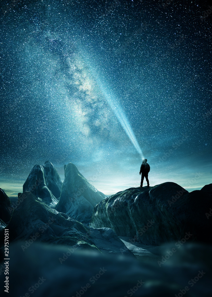 Wall mural the milky way lighting up the night sky with a man shining a flashlight towards it. photo composite.