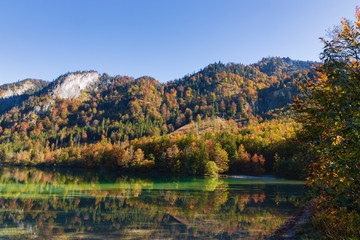 Fototapeta na wymiar Autumn sunny day on the lake Offensee, path along the lake Offensee. Salzkammergut, Austria