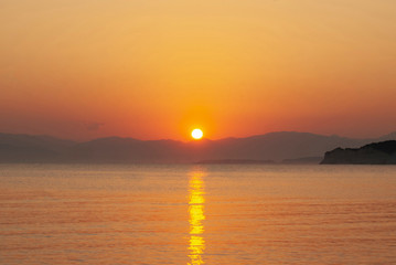 Sunset on the greek coast of the mediterranean sea
