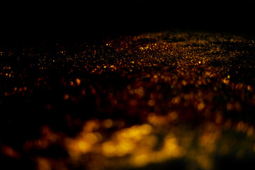 Fototapeta na wymiar golden glitter sparkle isolated on black background