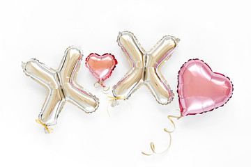 XO foil balloon letters and air balloons of heart shaped. Love concept. Holiday and celebration. Valentine's Day or wedding/bachelorette party decoration. Colorful Metallic  air balloons.