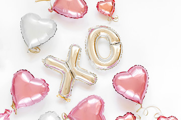 XO foil balloon letters and air balloons of heart shaped. Love concept. Holiday and celebration. Valentine's Day or wedding/bachelorette party decoration. Colorful Metallic  air balloons.