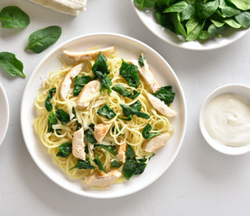 Spaghetti with spinach leaves, grilled chicken breast and cheese