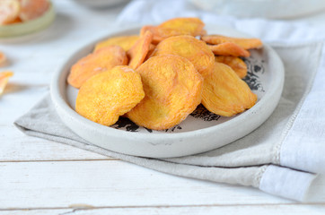 dried apricots on a white wooden background