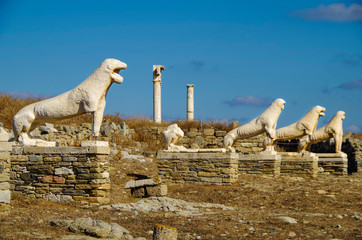 Ancient and historic temple ruins with columns and walls on archeologic site museum island Delos excavation site in Greece in the Aegean Sea with Apollon Sanctuary - obrazy, fototapety, plakaty