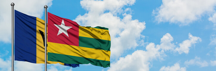 Fototapeta na wymiar Barbados and Togo flag waving in the wind against white cloudy blue sky together. Diplomacy concept, international relations.