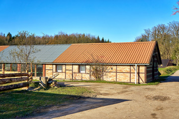 Fototapeta premium Small long half-timbered house with red tiled roof.