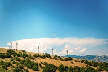 Wind power plant against the blue sky