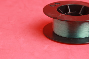 roll of nylon fishing line in color background