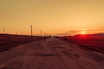 Fototapeta na wymiar Red golden sunset in the flat terrain