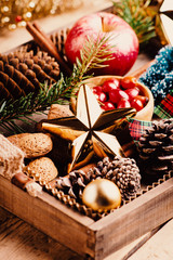 Variety of Christmas and New year decorations  in wood tray over rustic background.  Flat lay, space.