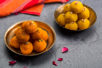 Naklejka na ściany i meble Motichoor Ladoo or Laddu - made from fine bundi, ball shaped sweets popular in indian subcontinent cooked with sugar, ghee or oil