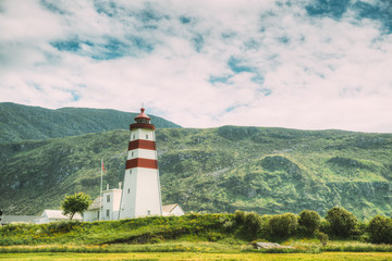 Fototapeta na wymiar Alnesgard, Godoya, Norway. Old Alnes Lighthouse In Summer Day In Godoy Island Near Alesund Town. Alnes Fyr