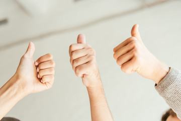 cropped view of brokers showing thumbs up