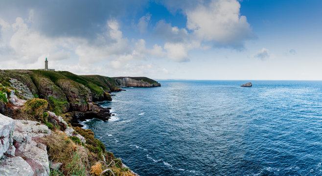 panorama coastal landscape with cliffs and a lighthouse