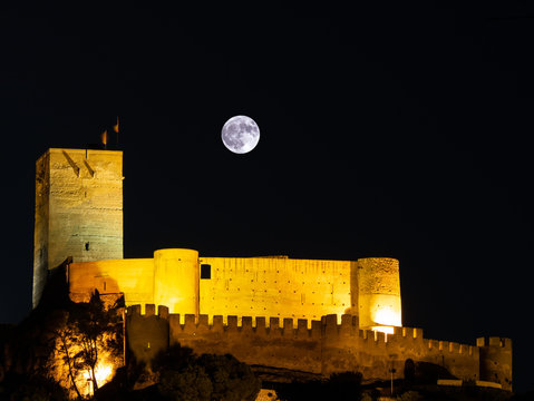  fortified castle illuminated with full moon