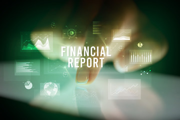 Finger touching tablet with charts and FINANCIAL REPORT inscription, business concept