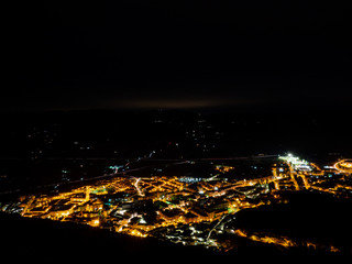 small town in the mountains illuminated at night
