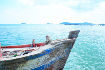 Obraz premium old fishing boat in the sea and blue sky