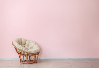 Soft armchair near color wall