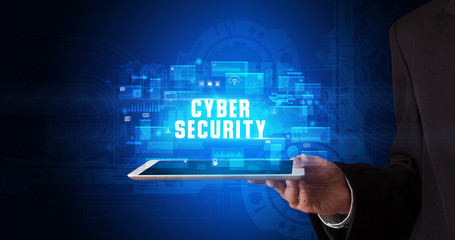 Young business person working on tablet and shows the digital sign: CYBER SECURITY