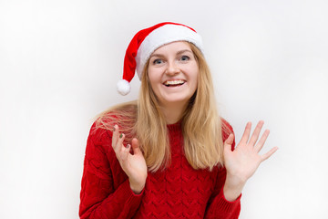 Young christmas woman wearing a santa hat and smiling. Holiday concept. Emotion facial expression.