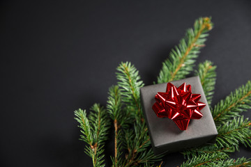 Christmas tree and gifts on gray background.