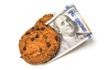 sweet eco-friendly cookies and 100 dollar bill. The concept of healthy, eco-friendly and affordable food. Isolated on a white background.