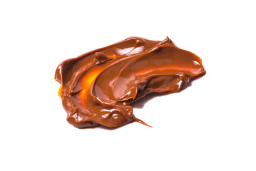 Melted tasty caramel splashes isolated on white background.