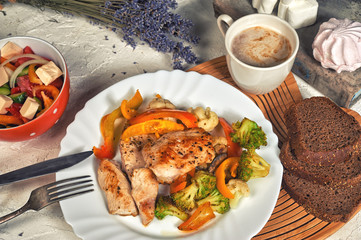 Fried chicken breast with vegetables on the table