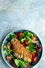 Grilled chicken breast with vegetabe salad. Top view with copy space.
