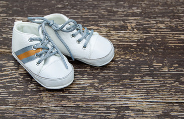 Baby boy cute shoes on wooden background