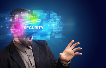 Businessman looking through Virtual Reality glasses with SECURITY inscription, innovative security concept
